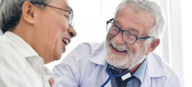 Senior doctor consulting with patient