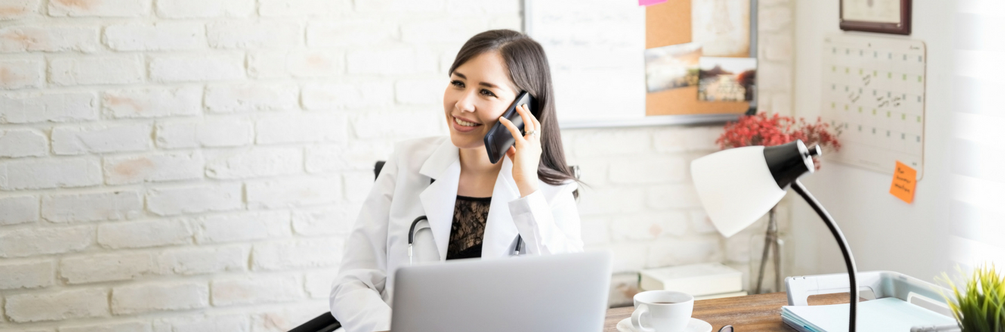 Physician on the phone while viewing computer