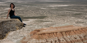 Dr. Caitlin Lees sitting on a ledge in the Grand Canyon