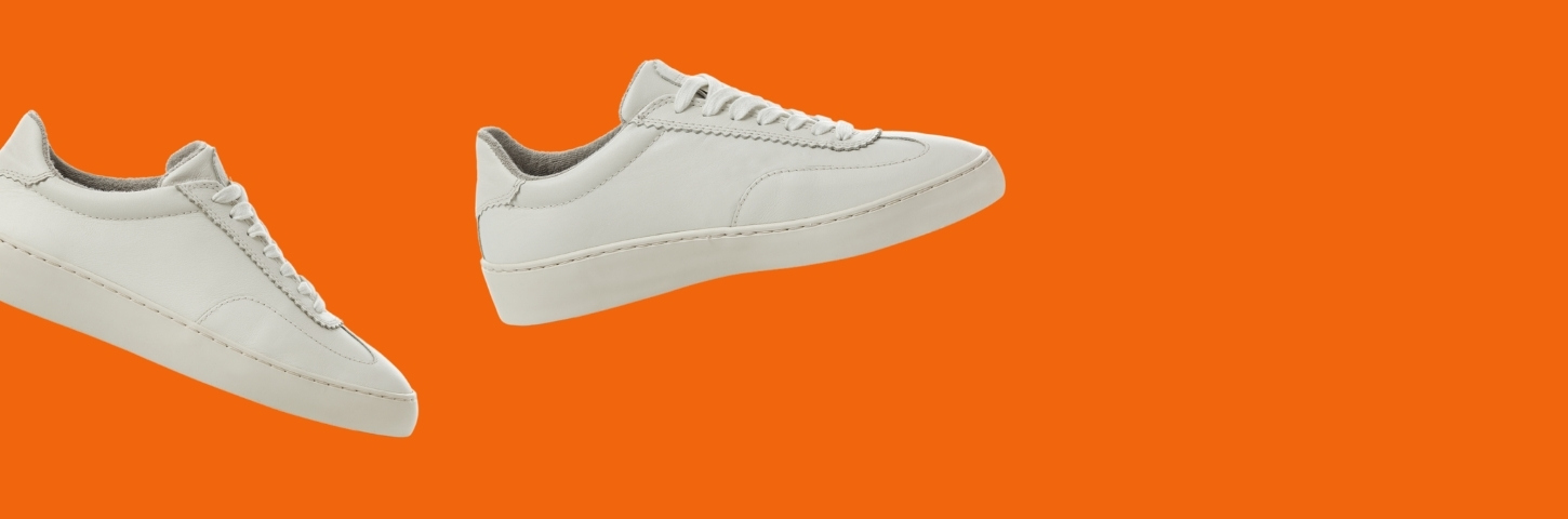 pair of sneakers on orange background