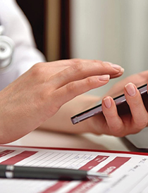 female physician holding smart phone