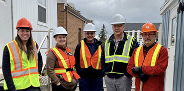 people wearing hardhats and safety vests at a construction site