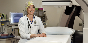 Dr. Alison Wallace wearing stethoscope and white coat