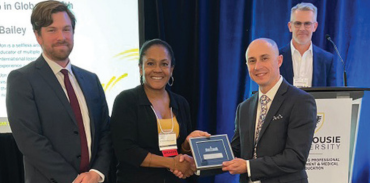 Drs. Brendan Morgan and Gaynor Watson-Creed congratulate Global Health award winner Dr. Jon Bailey