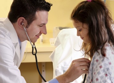 physician and child patient holding a stethascope