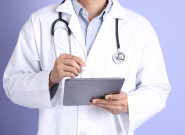 physician holding a tablet 